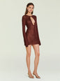 Front view of bronze metallic knit mini dress with a large teardrop cutout and long sleeves. thumbnail image 4 of 6