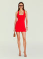 Front view of a model in a red Emmeline Mini Dress with scoop neckline and gold jewelry. thumbnail image 1 of 5