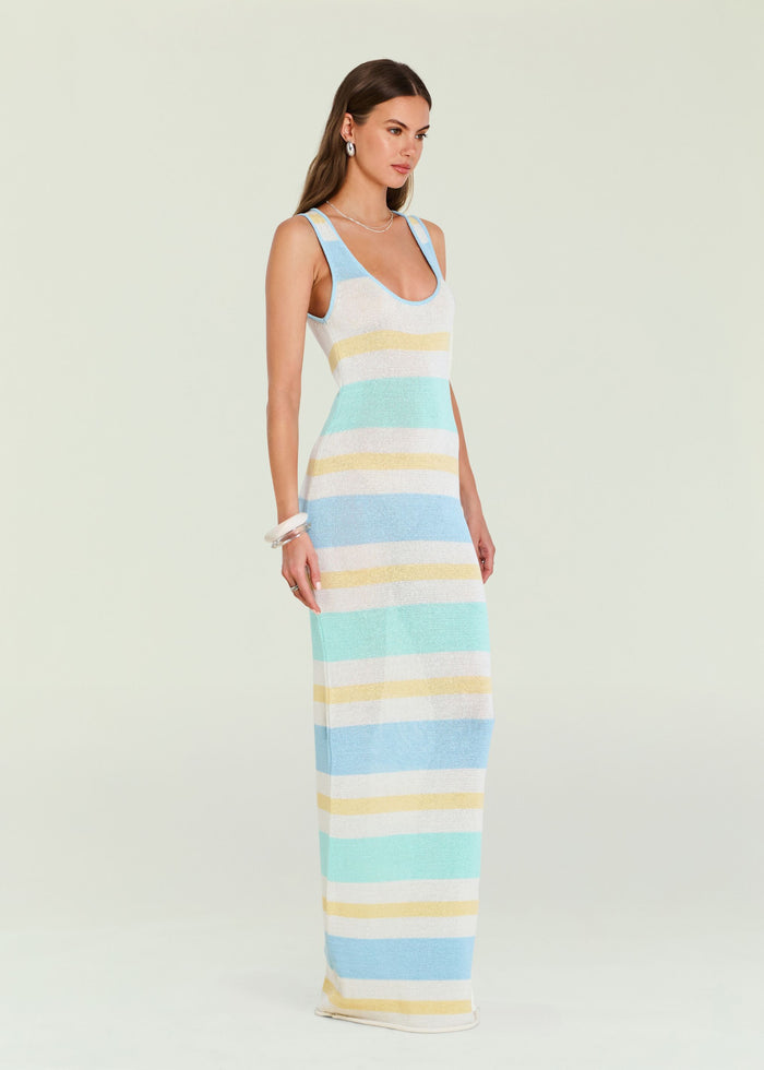 Side profile of a model in a pastel striped Jasmine Knit Dress with silver hoop earrings and layered necklace