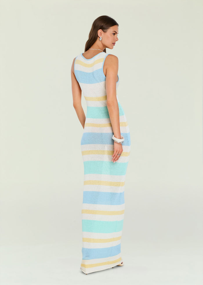 Side back view of a pastel striped sleeveless knit maxi dress on a model