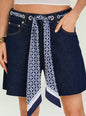 Close up of dark denim shorts with a blue patterned scarf belt tied at the waist showing belt loops and pockets thumbnail image 4 of 6