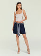 Model wearing Sabrina Boyfriend Shorts with scarf belt and cropped white tank, accessorized with sunglasses on head and a cream handbag. thumbnail image 3 of 6