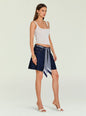 Model wearing Sabrina Boyfriend Shorts with a blue patterned scarf belt over dark denim and a white ribbed tank. thumbnail image 5 of 6