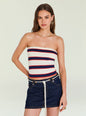 Model wearing Theodora Knit Top a strapless navy white red striped knit tube top with gold hoop earrings thumbnail image 1 of 5