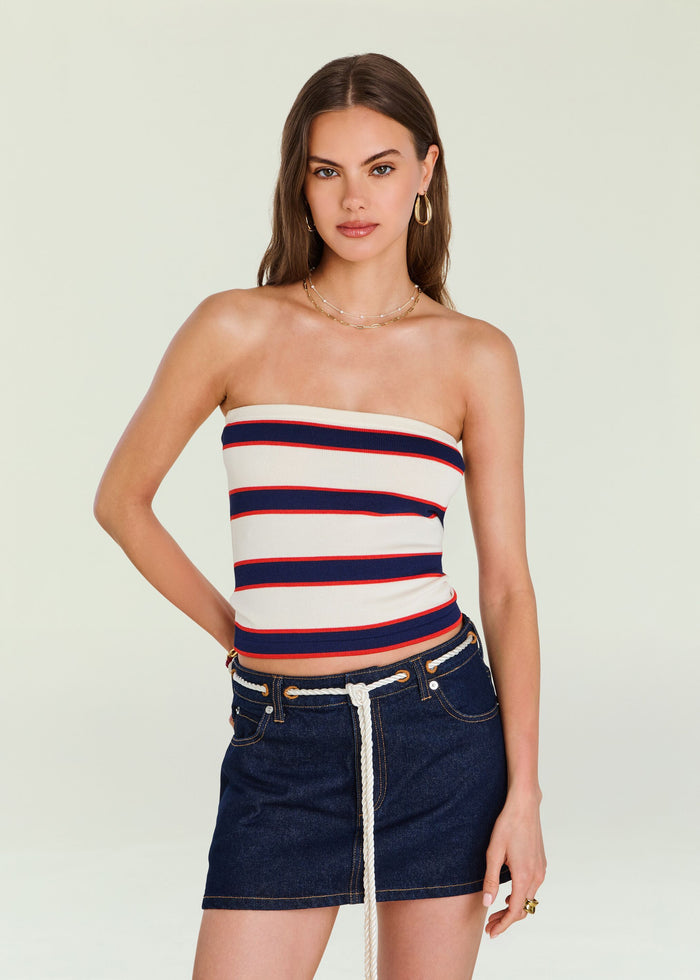 Model wearing Theodora Knit Top a strapless navy white red striped knit tube top with gold hoop earrings