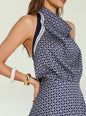 Close up of upper body highlighting halter neckline and navy and white geometric print with striped trim on the Winny Mini Dress thumbnail image 3 of 6