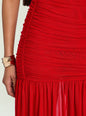 Close-up of a red dress with a person wearing a gold bracelet on a light background thumbnail image 2 of 5