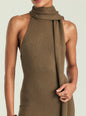 A close-up of a model wearing a ribbed knit halter-neck dress in a warm taupe-brown color, featuring a draped cowl neck detail. thumbnail image 2 of 5