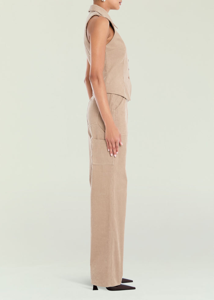 Side view of tan corduroy pants with cargo pockets worn with a sleeveless top.