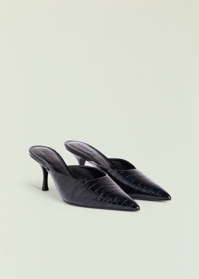 Two black crocodile-embossed Bonnie mules with pointed toes and slim heels resting on a pale background