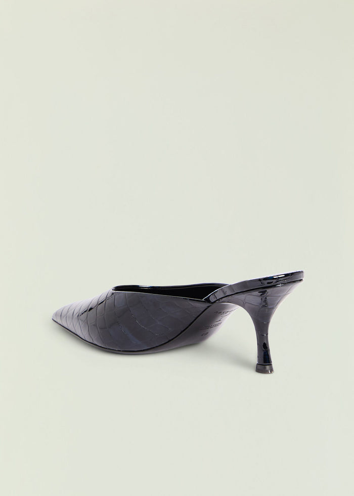 Black crocodile-embossed leather Bonnie mule with a pointed toe and mid heel viewed from the side