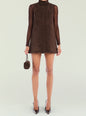 Carina Suede Mini Dress in chocolate brown worn sleeveless with a sheer long sleeve top and small brown handbag. thumbnail image 1 of 5