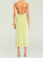 Back view of the lime green Carli Midi Dress on a model with a low back halter neckline and gold cuff bracelet. thumbnail image 4 of 5