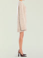 Side view of a beige knitted Daniela Sweater Dress on a model with ribbed cuffs and hem, paired with burgundy heels. thumbnail image 3 of 5
