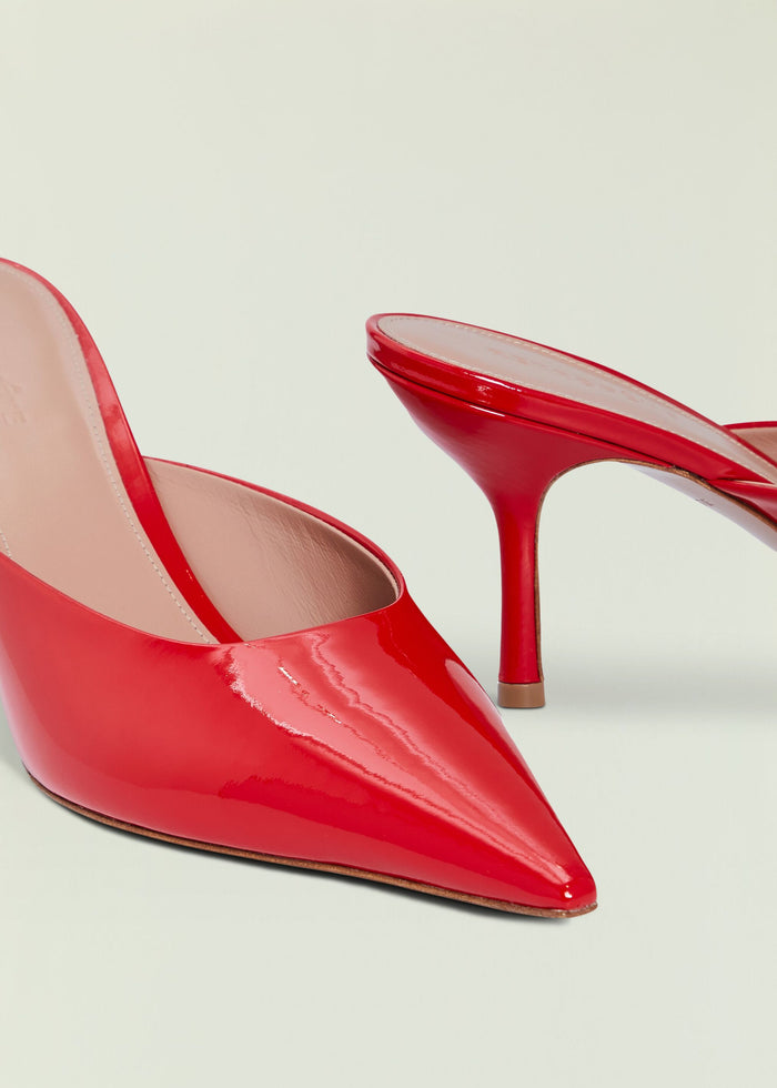 Red patent leather high heel with pointed toe and curved stiletto heel in profile