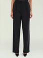 Front view of black Sonya pants with belt loops and a pleated front on a model. thumbnail image 1 of 5