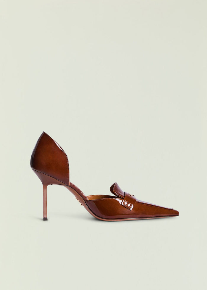 Brown glossy high heel with a pointed toe against a pale background