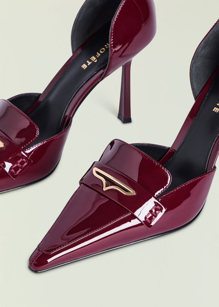 Close-up of burgundy patent leather Lida Loafer with a gold buckle accent.