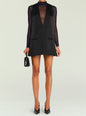 Hadley A Line Dress on a model with a sheer black turtleneck underlay and a sleeveless black dress, paired with a small handbag. thumbnail image 1 of 4