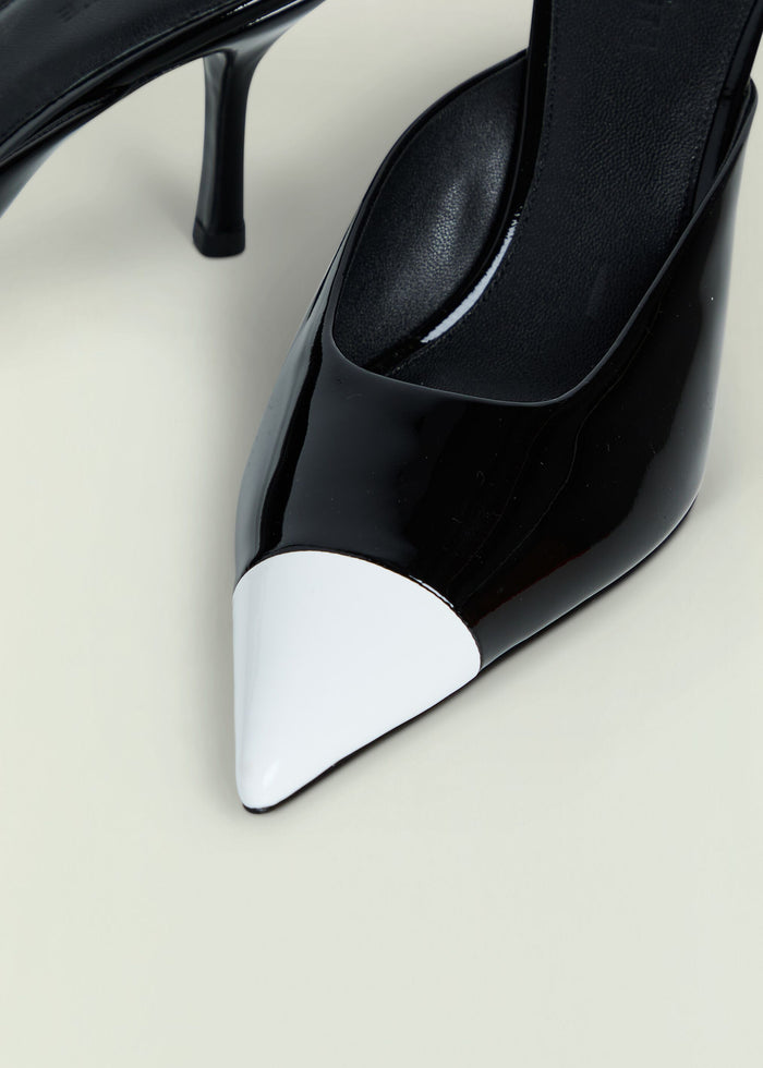 Allegra Leather Kitten Mule close-up of black glossy shoe with white toe cap.