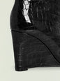 Close up of glossy black crocodile-embossed Natassa Wedge Boot displaying its textured pattern. thumbnail image 4 of 5