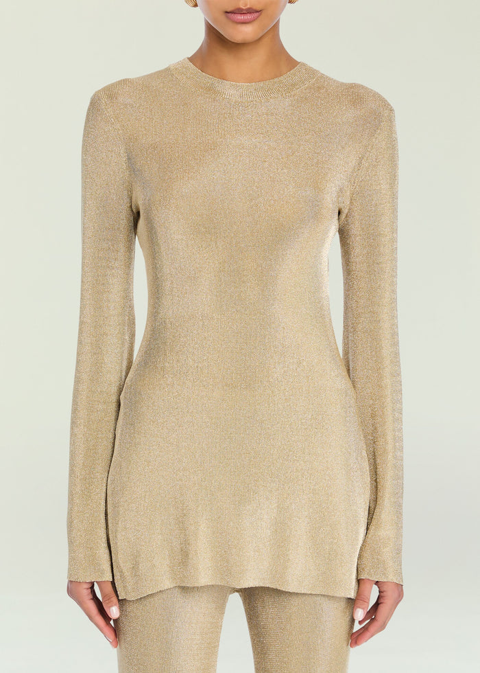 Gold metallic knit top on a model showcasing a shimmering knit texture.