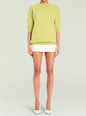 Lime green Jacey Sweater with ribbed cuffs and hem worn over a white mini skirt thumbnail image 2 of 5