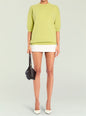 Bright lime Jacey Sweater in relaxed fit with 3/4 sleeves worn over a white skirt and black handbag. thumbnail image 1 of 5