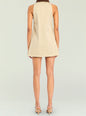 Back view of beige sleeveless mini dress with a brown collar and strappy sandals. thumbnail image 4 of 5