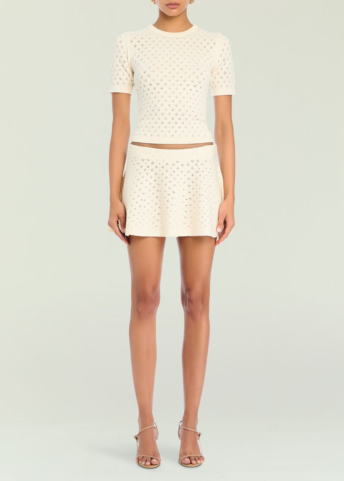 Cream pointelle knit top with short sleeves and matching knit skirt