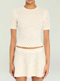 Cream Josie Pointelle Knit Top with short sleeves and a crew neck on a model. thumbnail image 1 of 5