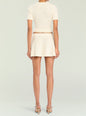 Back view of a model wearing the Josie Pointelle Knit Top with matching cream skirt thumbnail image 4 of 5