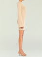 Beige knit mini dress with an off shoulder neckline shown in side profile with strappy sandals thumbnail image 3 of 5