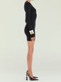 Side view of a model wearing a black long sleeve mini dress and pointed toe heels thumbnail image 3 of 5
