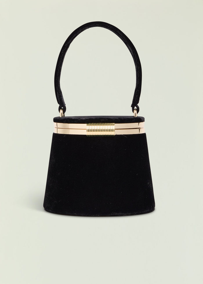 Lesla Case black velvet handbag with curved handle and gold frame open at the top.