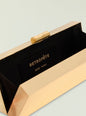Milo clutch featuring a pale gold ribbed exterior with black interior and gold hardware. thumbnail image 3 of 3