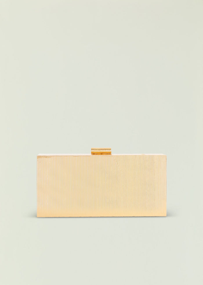 Milo clutch in pale gold with vertical ribbed texture and a small top handle.