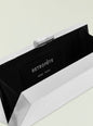 Close up of Milo Clutch top edge with ridged silver frame and small curved clasp. thumbnail image 3 of 3