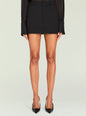 Front view of Lillith Mini Skirt in black on model with a clean silhouette and belt loops. thumbnail image 1 of 5