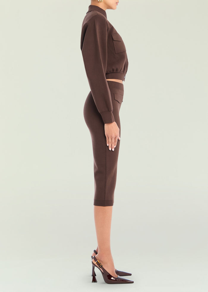Side view of brown Opal Midi Skirt on a model wearing a cropped top