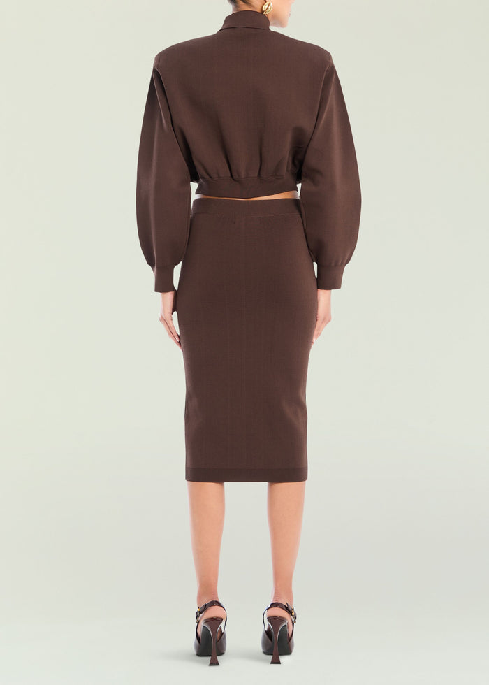 Back view of a brown cropped knit top with a matching midi skirt, showcasing an elastic waist.