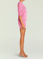 Side view of a pink metallic knit Rae two piece set with a short sleeve top and matching mini skirt. thumbnail image 3 of 5