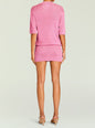 Back view of pink metallic knit Rae two piece set with a relaxed top and fitted mini skirt. thumbnail image 4 of 5
