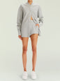 Model wearing a gray knit Arlo Short set with a button front cardigan partially open to reveal midriff thumbnail image 5 of 5