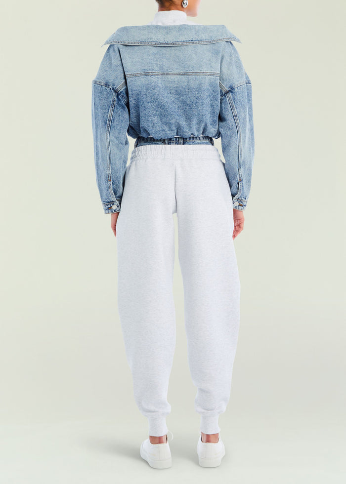 Back view of a model in an oversized blue denim jacket paired with gray Klara Sweatpant