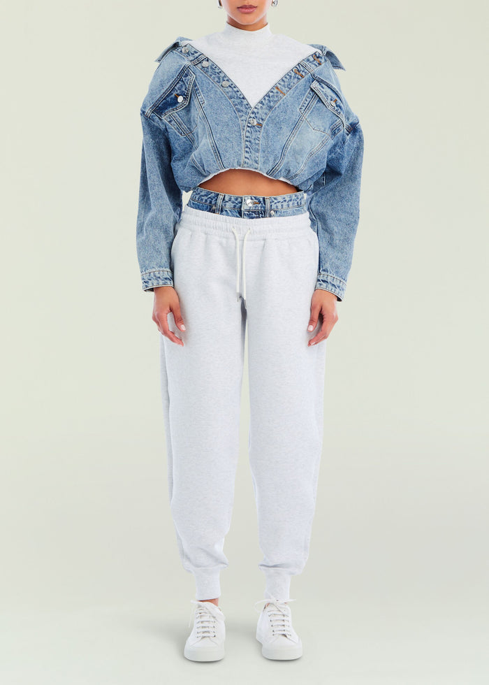 Full body shot of a model wearing light gray Klara Sweatpants with a cropped denim jacket over a white top