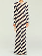 Model wearing a Rubi Knit Maxi Dress with navy cream diagonal stripes, full length, holding a beige handbag. thumbnail image 1 of 5