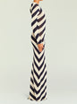 Side view of a model in the Rubi Knit Maxi Dress with bold navy and cream diagonal stripes. thumbnail image 3 of 5