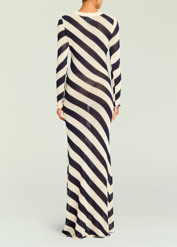 Back view of a navy and cream diagonal striped knit maxi dress with long sleeves.
