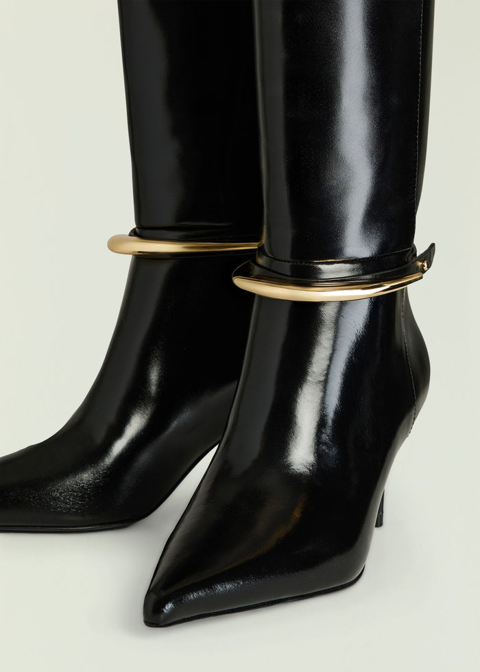 Sancia Boot black patent knee high boot with gold ring hardware around the shaft